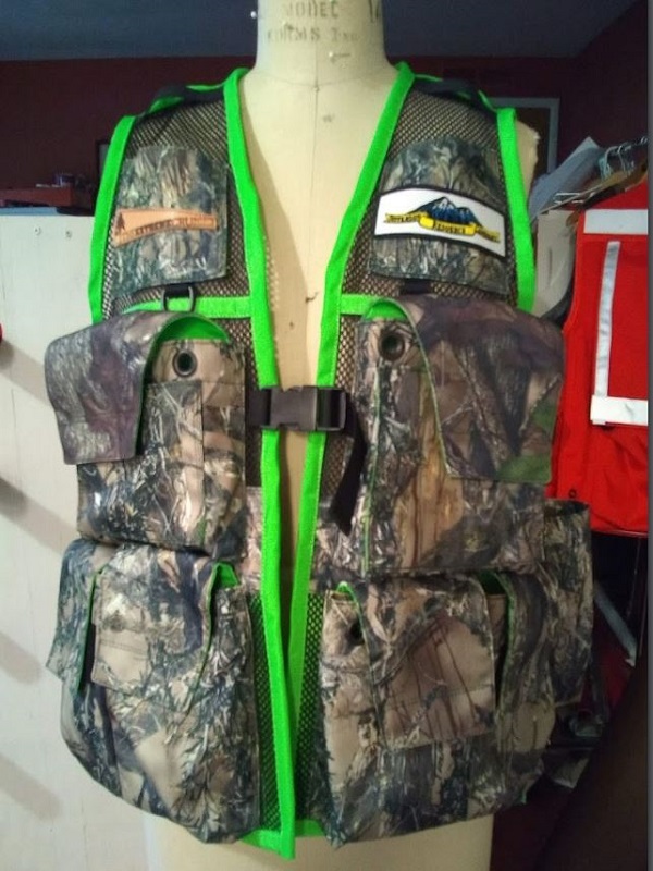 Image of A Woman's Siskiyou Extreme Cruiser Vest In Camo With Fluorescent Green Binding